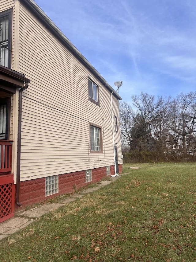 view of home's exterior with a lawn