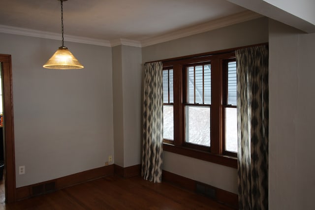 empty room with crown molding and dark hardwood / wood-style floors