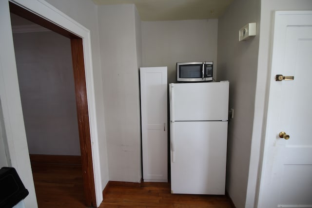 kitchen with dark wood-type flooring and white refrigerator