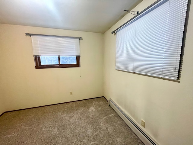 carpeted spare room with baseboard heating