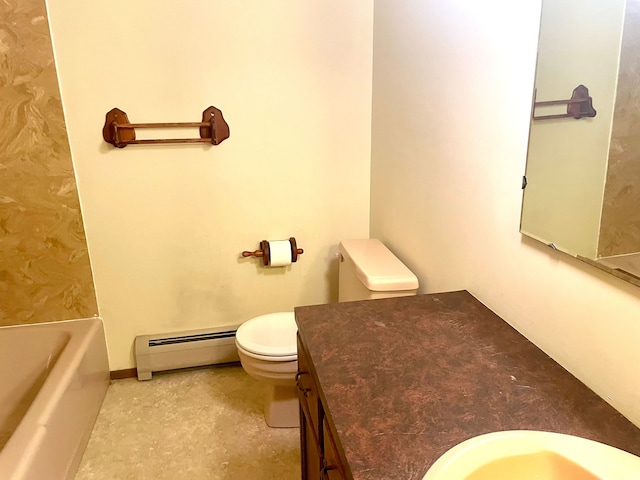 bathroom featuring vanity, a tub to relax in, toilet, and baseboard heating