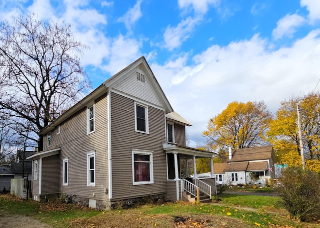 back of property featuring covered porch