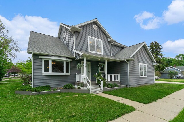 500 Myrtle Ave, Sturgis, MI 49091 - traditional home with a porch, a front lawn, and roof with shingles