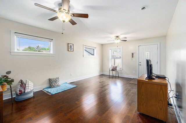 500 Myrtle Ave, Sturgis, MI 49091 - unfurnished living room with a ceiling fan, dark wood-style flooring, and baseboards