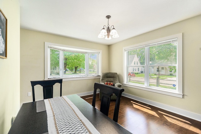 500 Myrtle Ave, Sturgis, MI 49091 - dining area with a chandelier, baseboards, and dark wood-style flooring