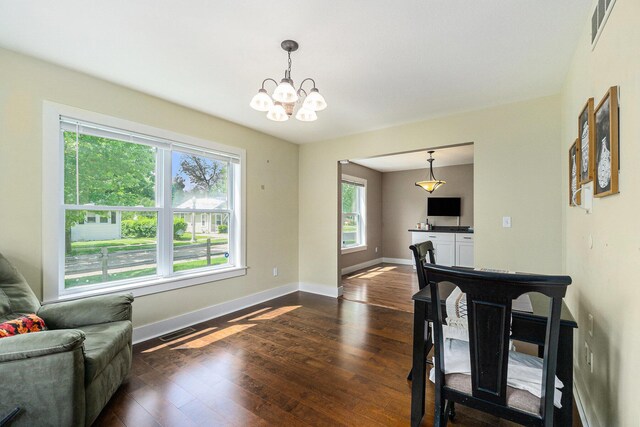 500 Myrtle Ave, Sturgis, MI 49091 - living area featuring dark wood-style flooring, a chandelier, and baseboards