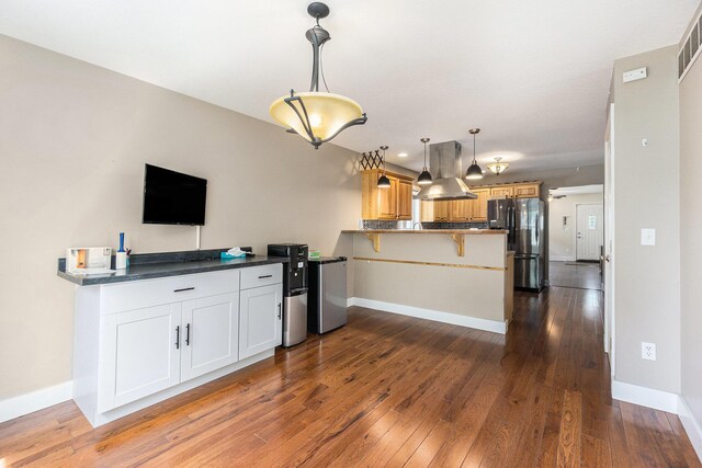 500 Myrtle Ave, Sturgis, MI 49091 - kitchen with freestanding refrigerator, a peninsula, baseboards, dark wood-style flooring, and recessed lighting
