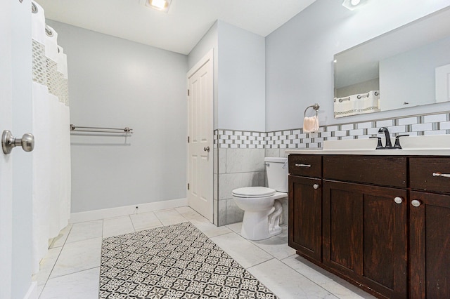 500 Myrtle Ave, Sturgis, MI 49091 - full bathroom with tile walls, toilet, vanity, and a wainscoted wall
