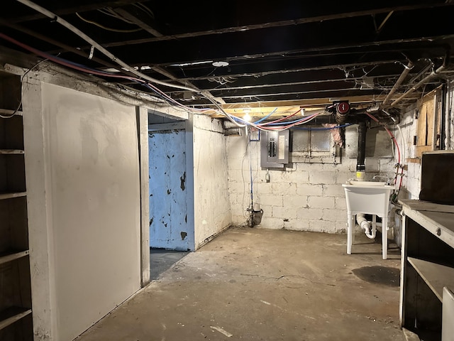 basement with sink and electric panel