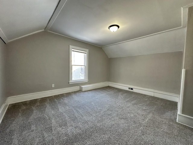 bonus room with carpet floors and vaulted ceiling