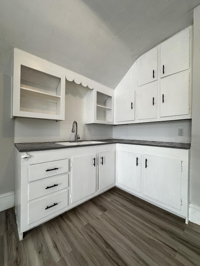 kitchen featuring dark hardwood / wood-style flooring, white cabinetry, and sink