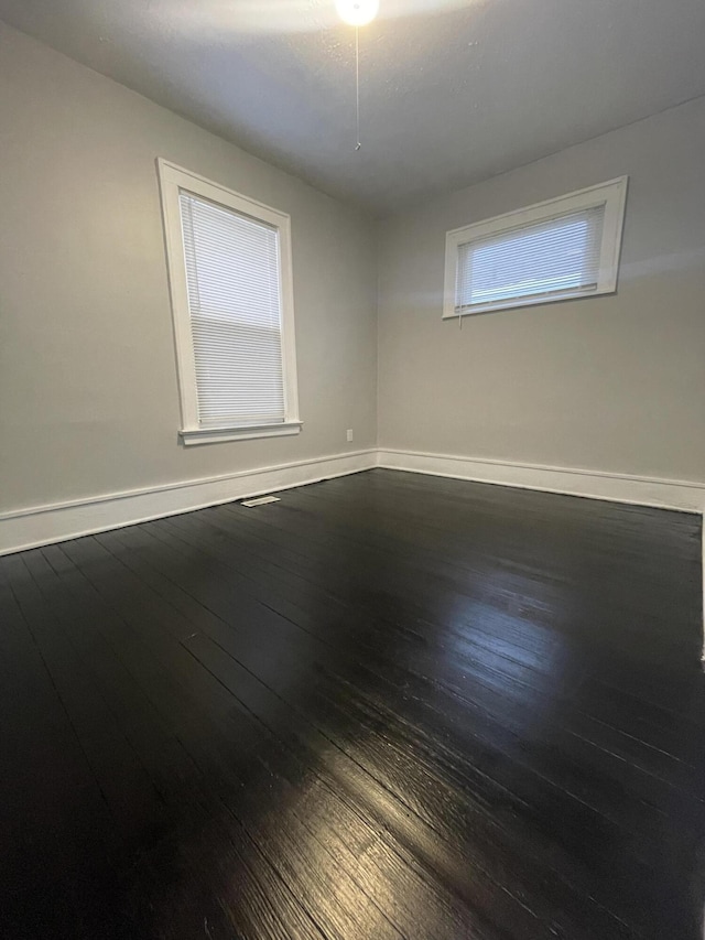 empty room with hardwood / wood-style flooring