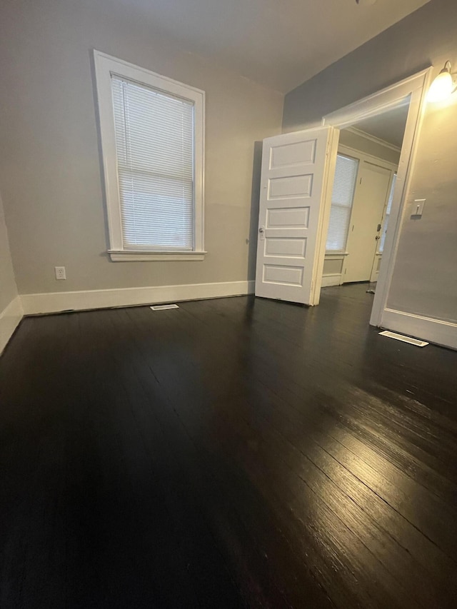 empty room featuring dark wood-type flooring