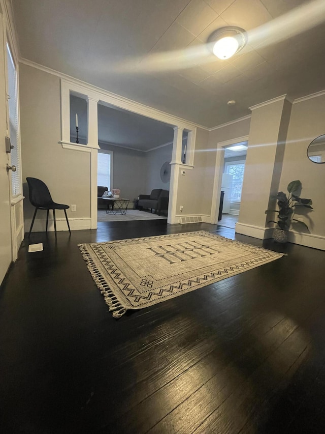 exercise room featuring wood-type flooring, plenty of natural light, and crown molding