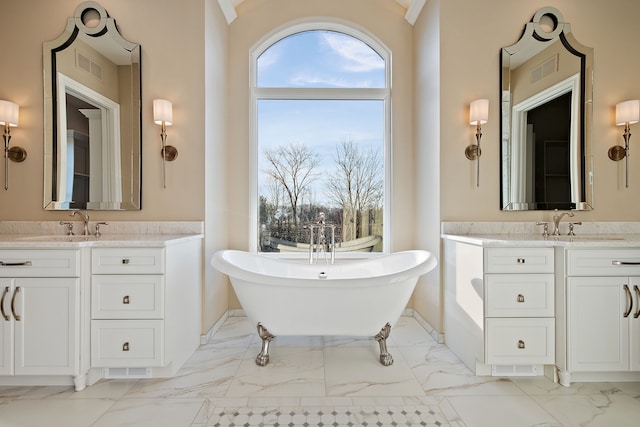 bathroom with vanity and a tub