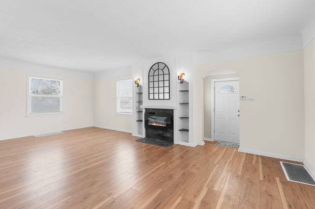 unfurnished living room with light hardwood / wood-style flooring