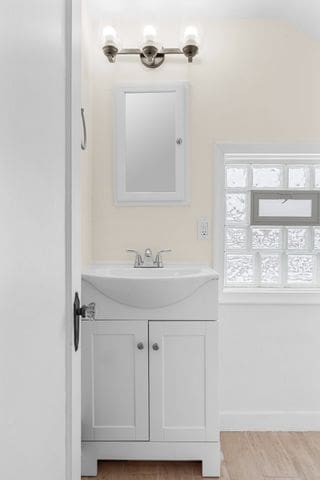 bathroom with vanity and hardwood / wood-style flooring