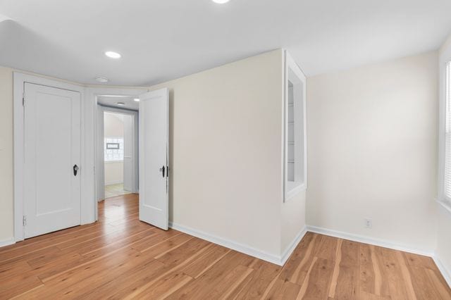 empty room with light hardwood / wood-style flooring