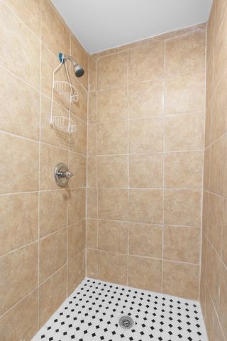 bathroom with a tile shower