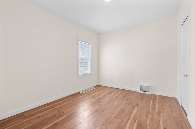 unfurnished room with light wood-type flooring