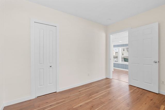 unfurnished room featuring hardwood / wood-style flooring