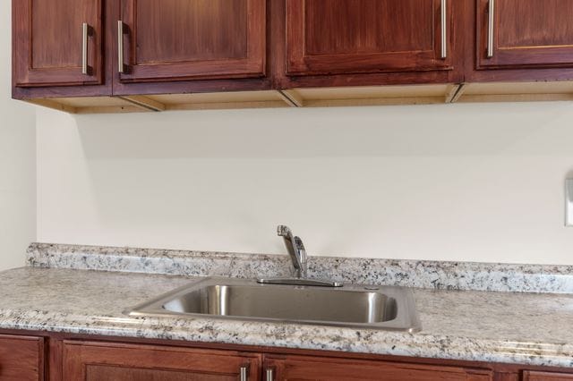 kitchen with light stone countertops and sink