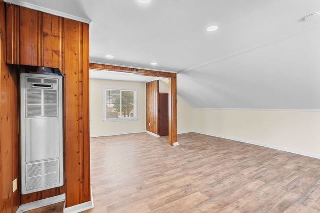 interior space with light wood-type flooring and lofted ceiling