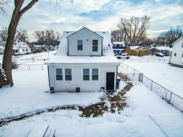 view of snow covered back of property