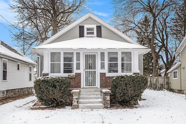 bungalow-style home with a sunroom