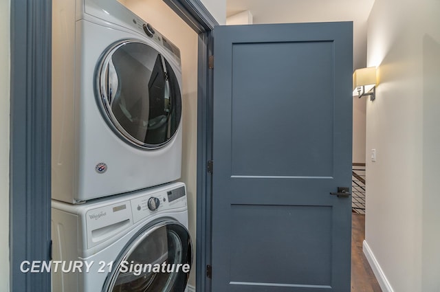 laundry room with stacked washer / drying machine and dark hardwood / wood-style flooring