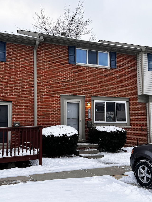 view of property with brick siding