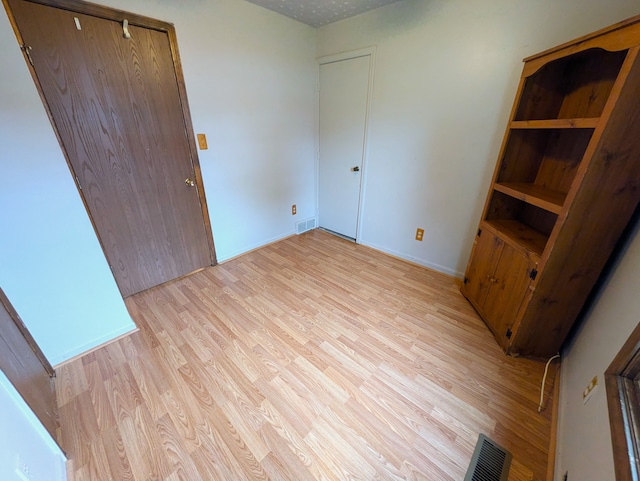 unfurnished bedroom featuring light wood-type flooring