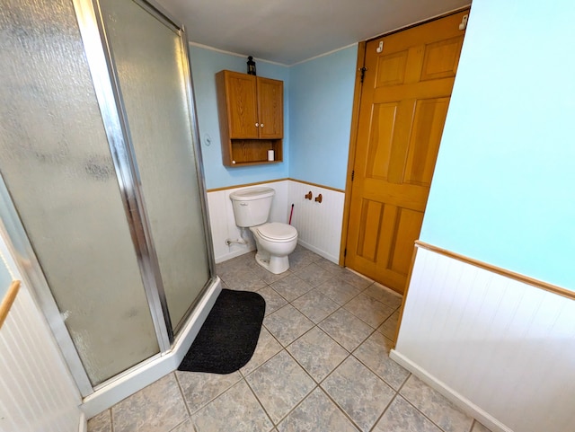 bathroom with tile patterned floors, toilet, and walk in shower