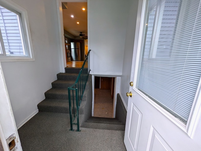 staircase featuring carpet and ceiling fan