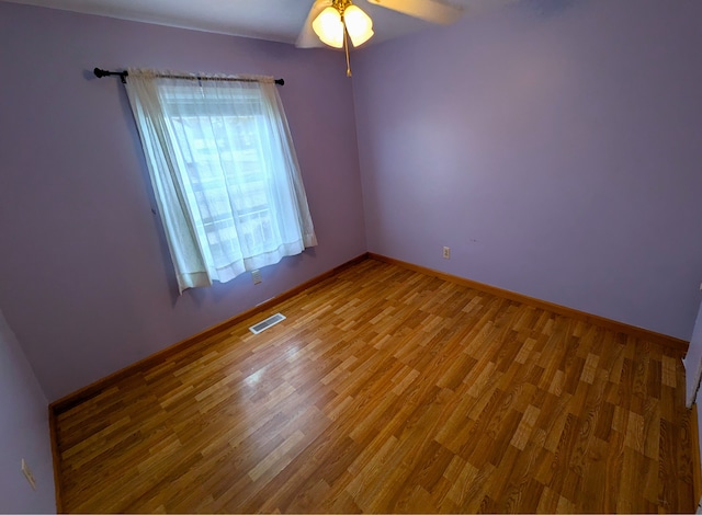 unfurnished room with ceiling fan and hardwood / wood-style floors