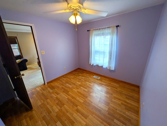 spare room featuring ceiling fan and light hardwood / wood-style flooring