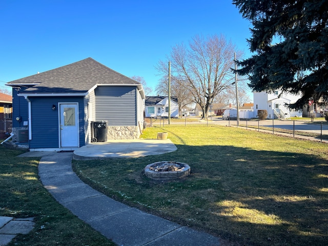 view of yard with central AC unit, a fire pit, and a patio