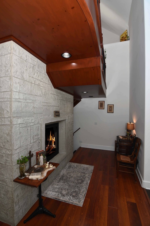 hall with dark hardwood / wood-style flooring and vaulted ceiling