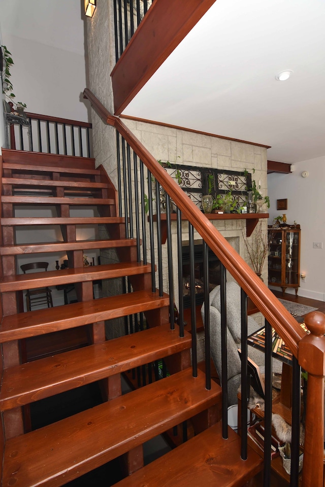 stairway featuring ornamental molding