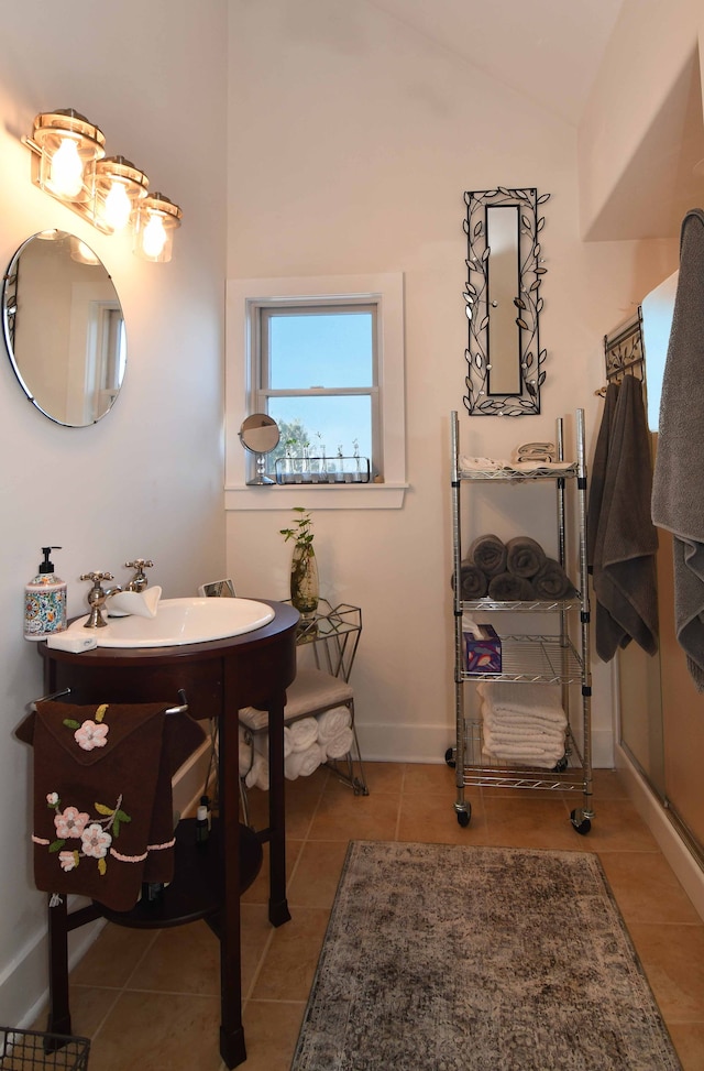 bathroom with vanity, tile patterned floors, and lofted ceiling