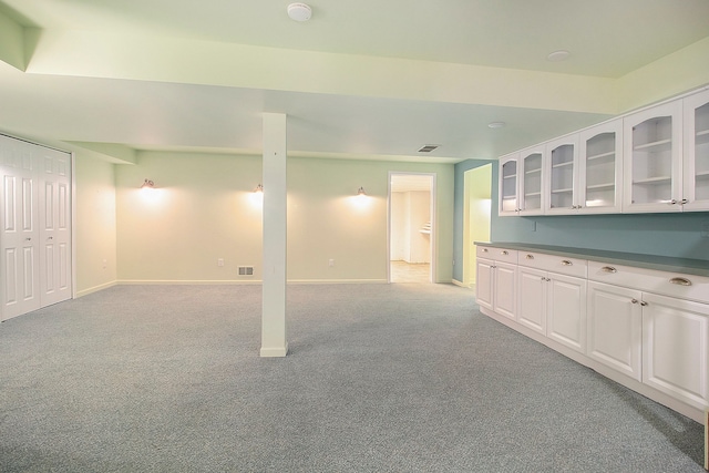 interior space with light colored carpet and white cabinetry