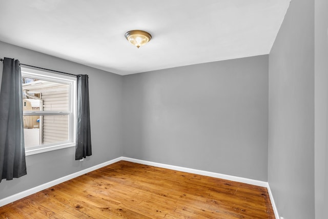 unfurnished room with hardwood / wood-style floors