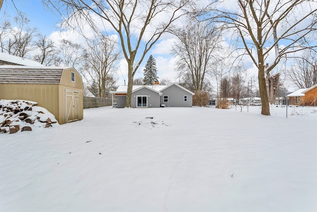 yard layered in snow with an outdoor structure