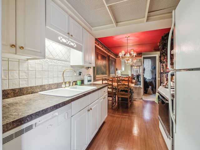 kitchen with sink, hanging light fixtures, white cabinets, white appliances, and backsplash