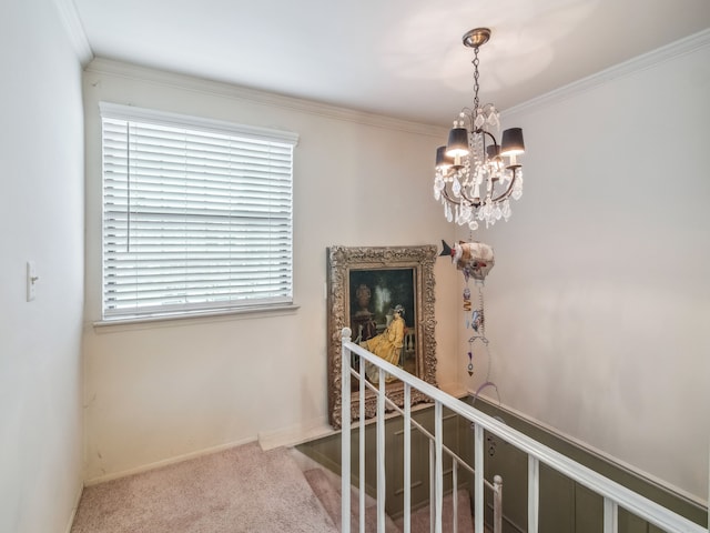 hallway featuring crown molding, carpet floors, and a notable chandelier