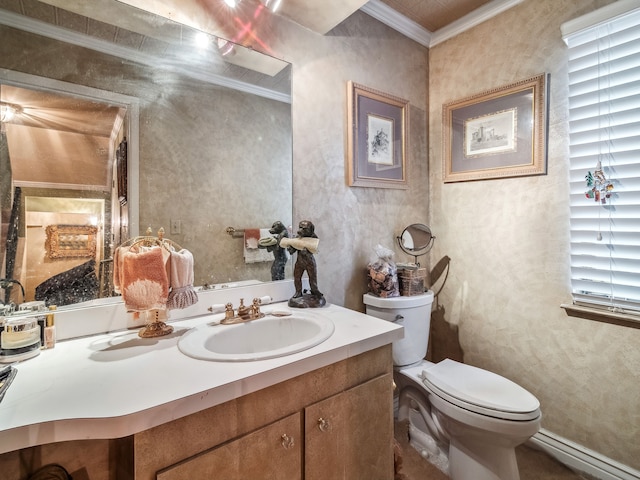 bathroom with vanity, ornamental molding, and toilet