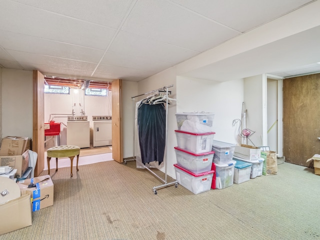 basement with carpet flooring, separate washer and dryer, and a drop ceiling