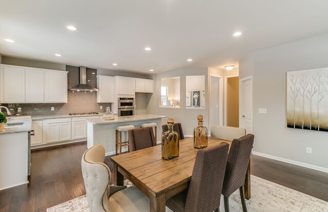 dining area featuring dark hardwood / wood-style flooring and sink