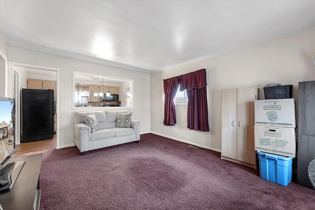 unfurnished living room with carpet and a chandelier