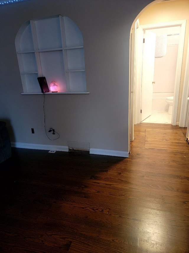 spare room with dark hardwood / wood-style floors